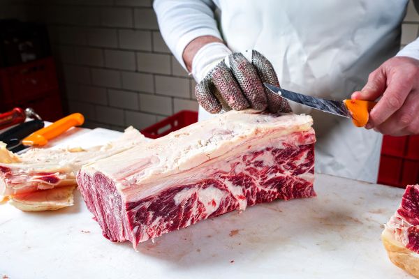 Raw dry aged wagyu Roast beef steak cut up by a butcher at the butchery as close-up